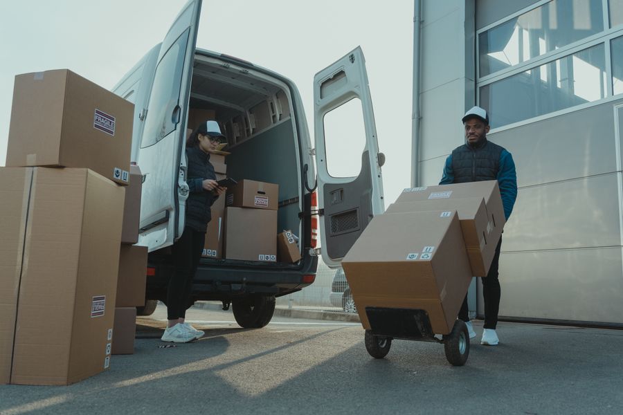Movers loading boxes into a van.